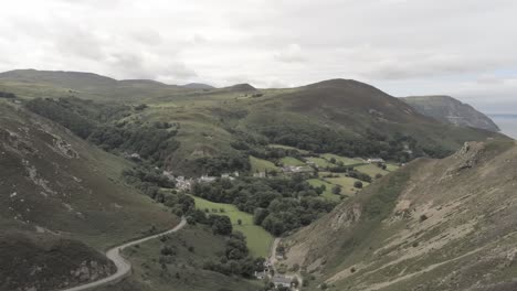 Capelulo-Penmaenmawr-Welsh-mountain-coastal-valley-aerial-view-north-wales-slow-wide-orbit-right