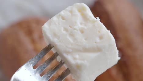 a cube of cheese on a fork