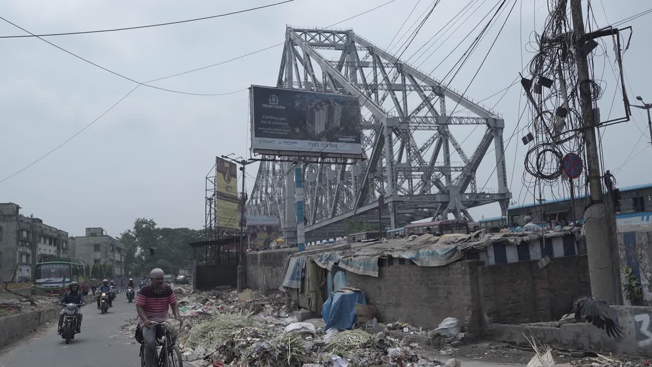 Howrah Bridge and Urban Life Amidst Pollution in Kolkata, India