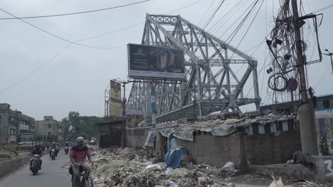 howrah bridge and urban life amidst pollution in kolkata, india