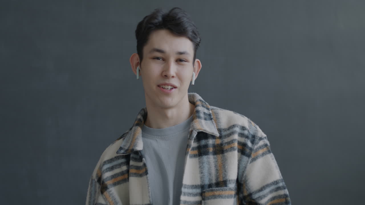 Smiling young man with earbuds