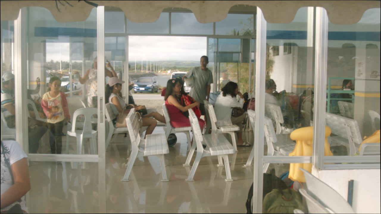 People waiting in line early in the morning at the Cadiz City New Port, Philippines. Travellers await ferry rides from Cadiz City New Port to Bantayan Island in the province of Cebu.