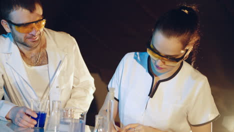 Young scientists conducting tests or research in the laboratory. Lab technician checks the test tubes.