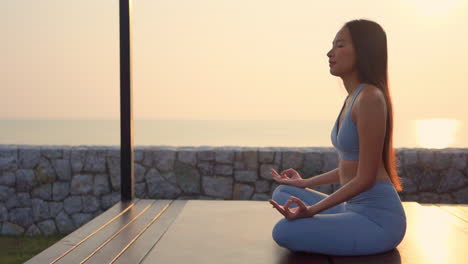 Meditation---Yoga-asian-woman-meditating-at-beach-sunset