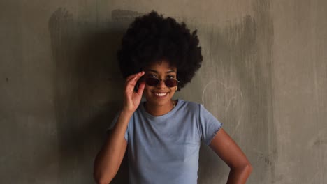 Front-view-of-mixed-race-woman-taking-off-sunglasses