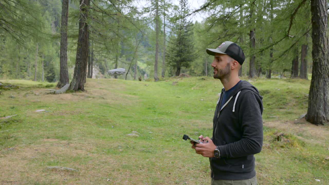 Man playing and testing Neo drone outdoor in natural landscape