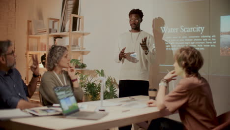 african american man discussing environmental issues with team during meeting