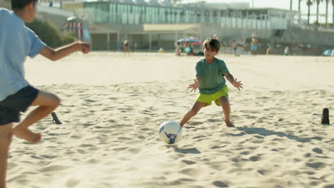 long shot of happy boy catching ball while playing soccer