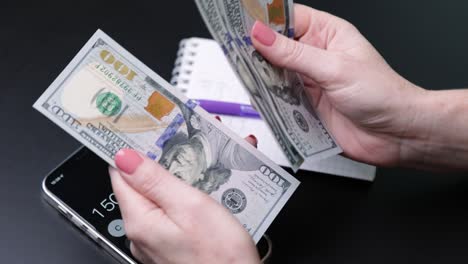 dollars in the hands of a woman, the girl counts banknotes, paper money. family budget, bill payment