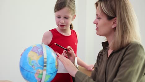 teacher and student learning geography with a globe