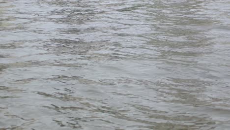 POV-to-the-water-surface-with-waves-while-on-the-boat-in-the-river