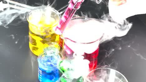 chemistry experiment with colorful liquids and smoke