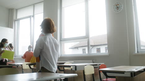 students with face masks entering classroom.