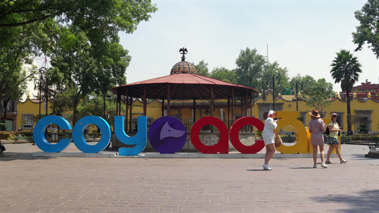 Coyoacan Town Colorful Letter Standee And Kiosk At Plaza Hidalgo In Mexico City, Mexico. wide shot