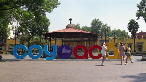 coyoacan town colorful letter standee and kiosk at plaza hidalgo in mexico city, mexico. wide shot