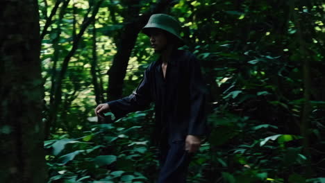 person walking through a dark jungle
