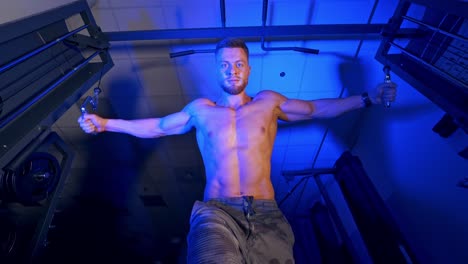 athlete with strong body doing work out pushing up excercise in gym. view from the bottom.