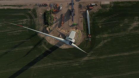 Aerial-descending-shot-of-construction-site.-Top-down-view-of--wind-turbine.-Green-energy,-ecology-and-carbon-footprint-reduction-concept