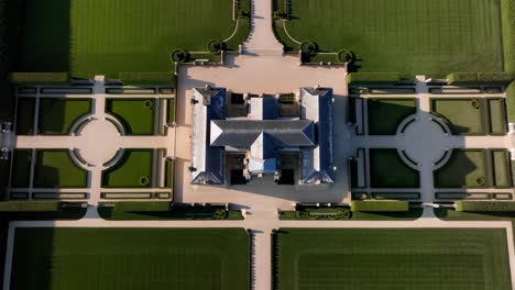aerial view of a grand mansion and formal formal gardens