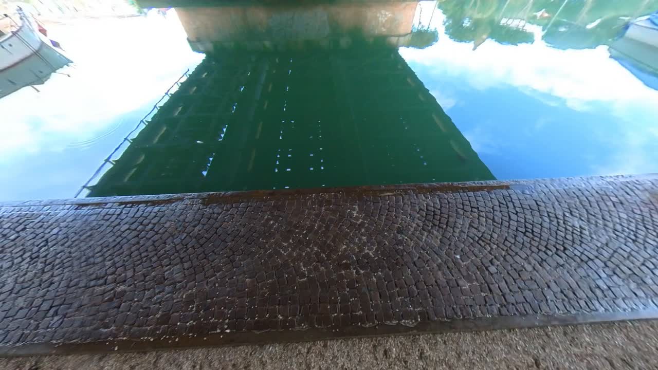 Reflective Canal Water with Cobblestone Dock