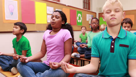 pupils doing yoga in classroom