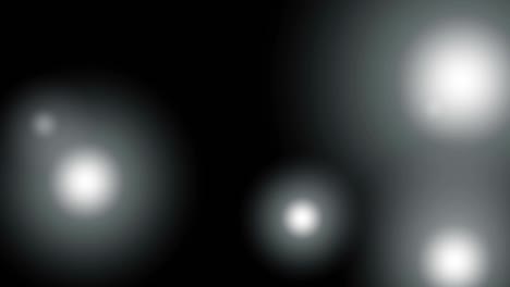 flickering white light circles on a black background