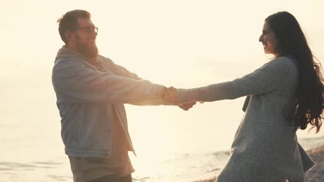 couple dancing on the beach at sunset