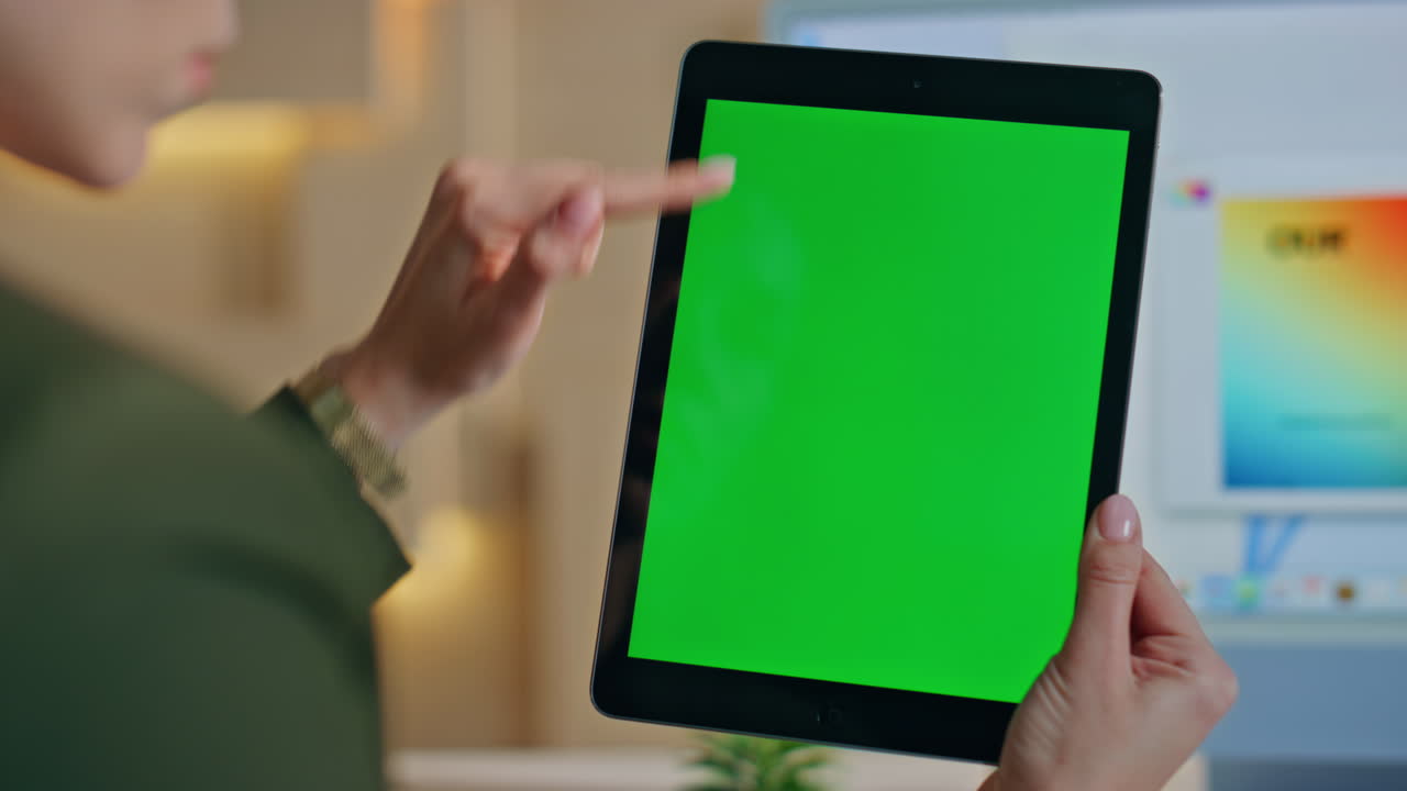 Unknown designer touching mockup tablet browsing app at workplace close up.