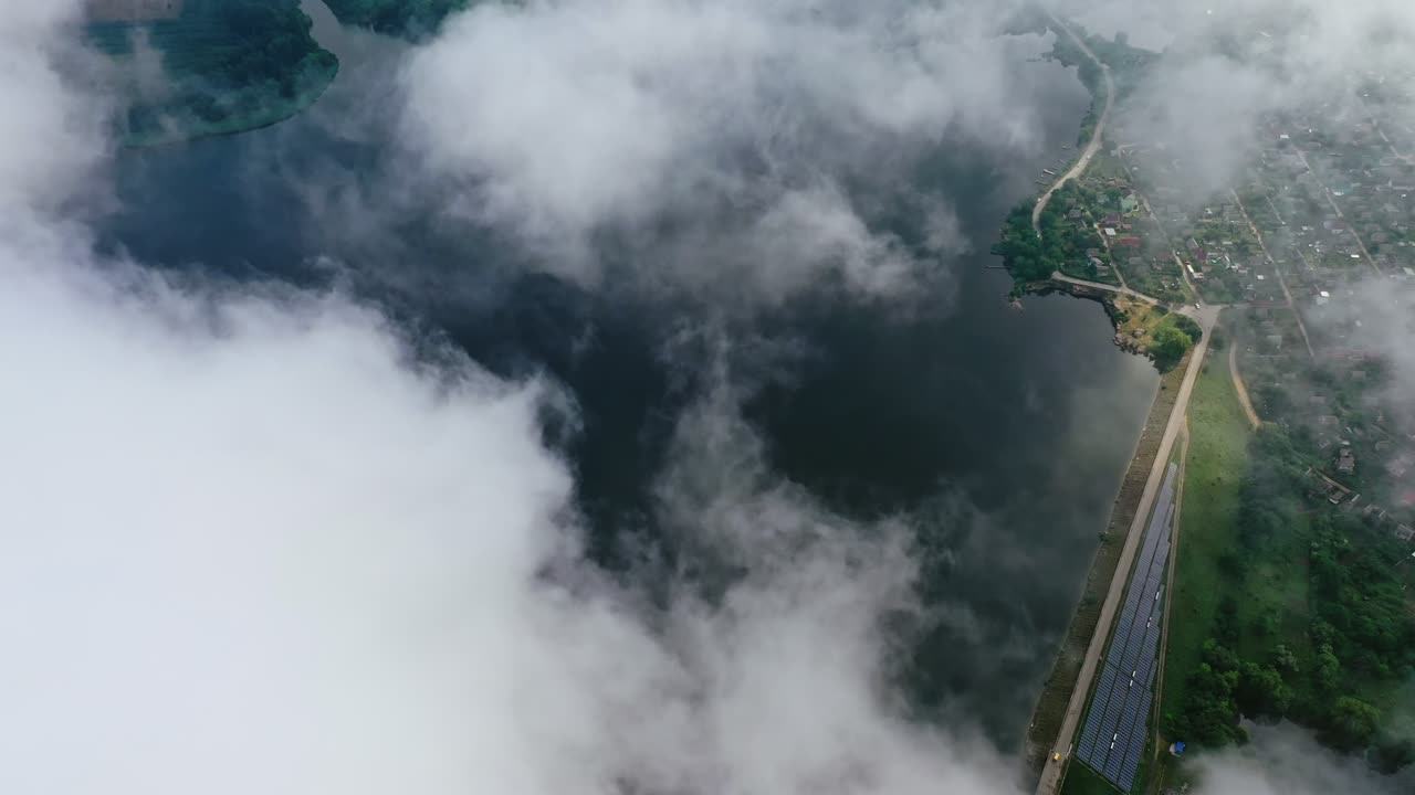 Amazing view from the sky. Flight among clouds on water background near the countryside. Aerial view.