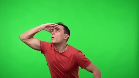 man in a red shirt seeing something in the distance