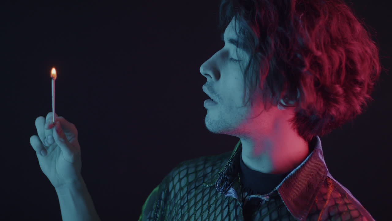 Man with Match and Smoke in Neon Lighting