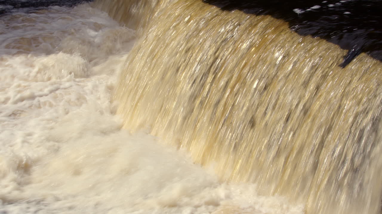 shot of water cascading over the lower falls at Aysgarth falls on the river ure, Yorkshire dales