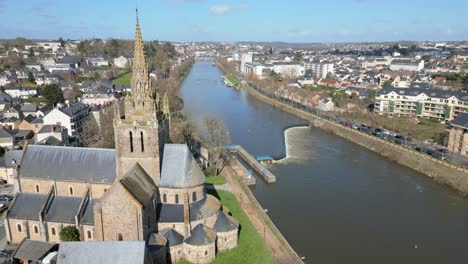 drone flying over basilica of notre-dame d'avesnières along mayenne river, laval in france