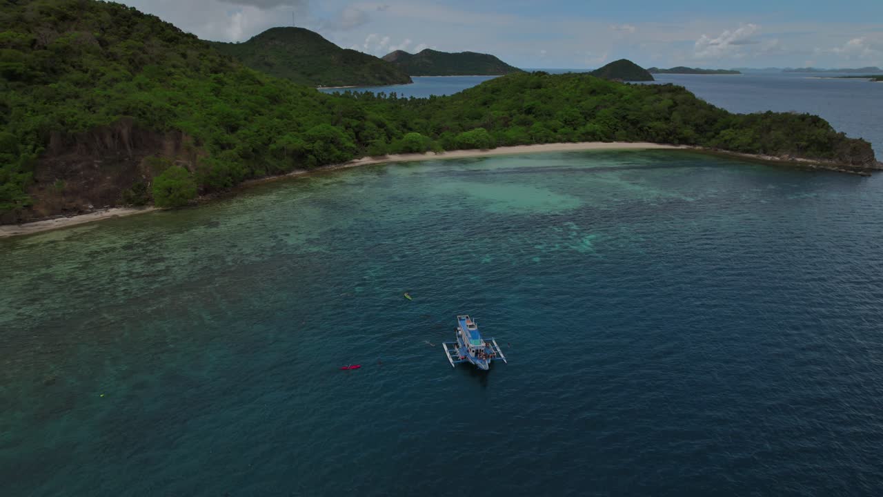 Aerial View of Tropical Island with Boat and Kayaks