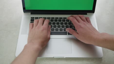 computer laptop green screen working with close-up man, using finger with keyboard for typing touch. computer laptop with blank green screen chroma key