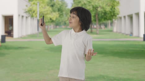 happy indian boy making a vlog in park