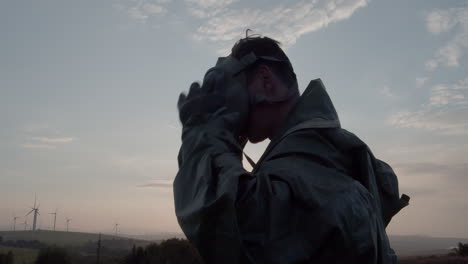 Portrait-of-a-man-in-an-anti-chemical-military-suit-putting-on-a-gas-mask