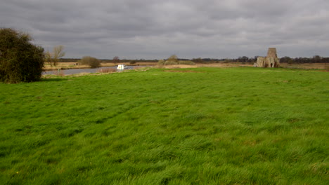 Wide-shot-of-St-Benet’s-abbey-16th-century-gatehouse-with-18th-century-windmill