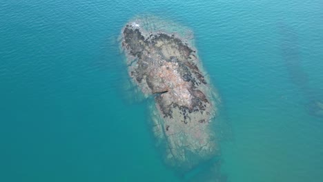 capturing the breathtaking solitude of an arid island amidst the endless expanse of cerulean waters