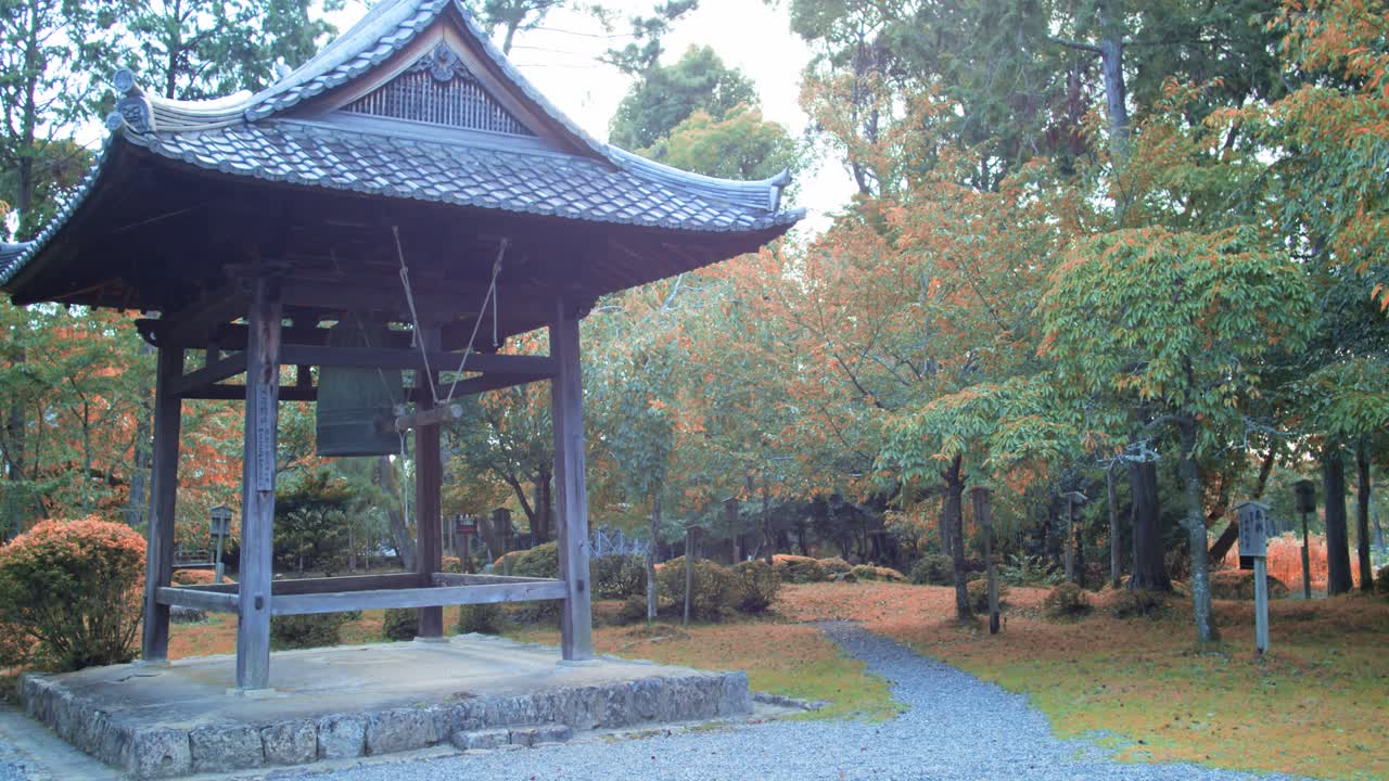 Peaceful Japanese garden with an old bell in Kyoto, Japan soft lighting slow motion 4K