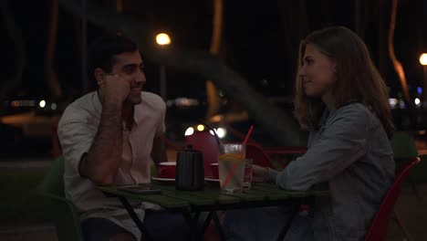 couple enjoying a night date at an outdoor cafe