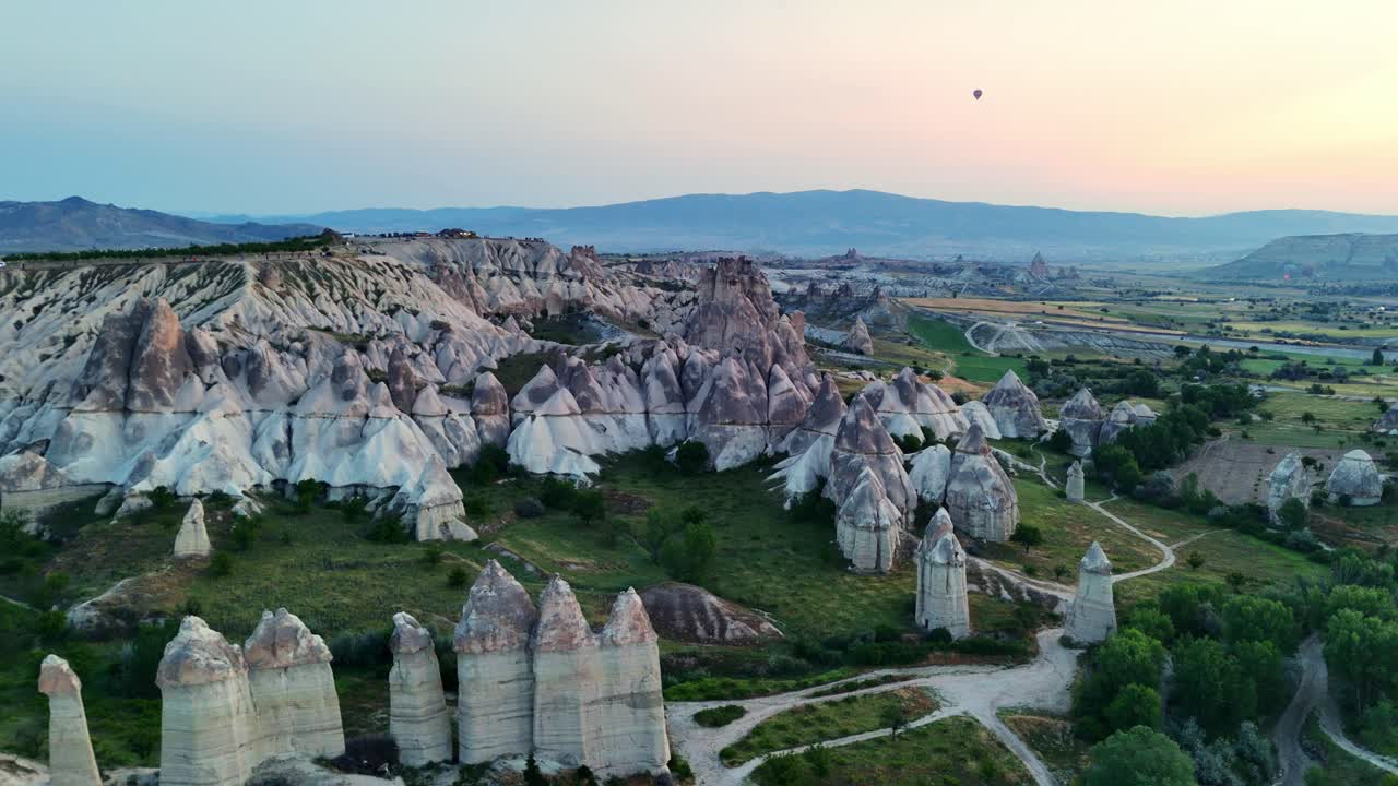 Scenic aerial view of Cappadocia's unique rock formations at sunset