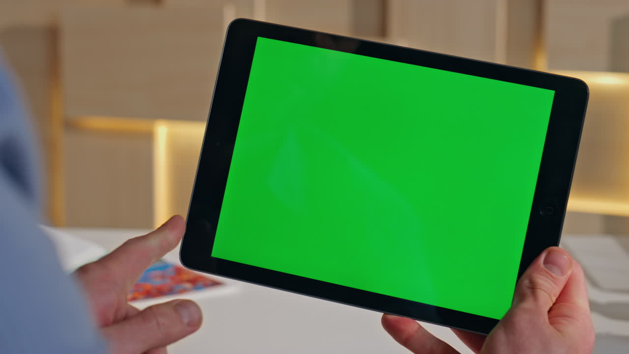 Ceo hand touching chroma key tablet checking work project at work desk close up.