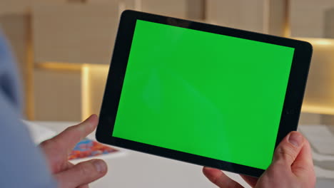 ceo hand touching chroma key tablet checking work project at work desk close up.