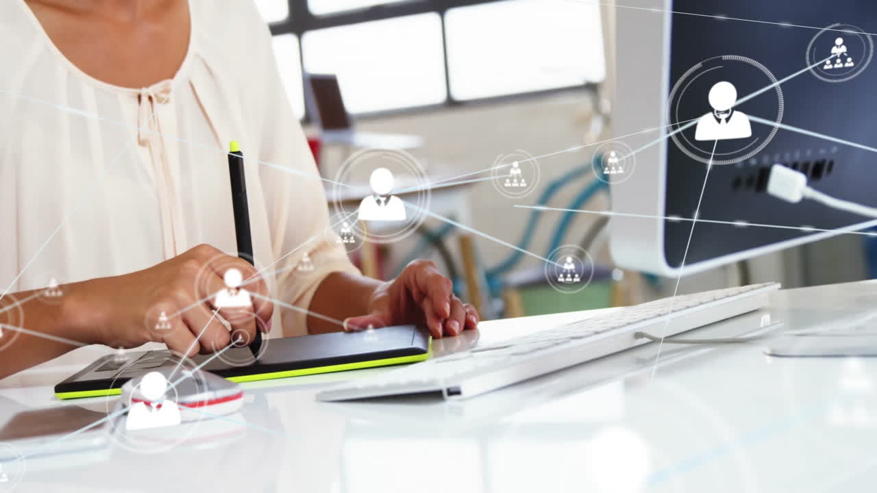 Using digital pen tablet, person working at desk with network connections animation