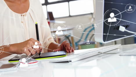 using digital pen tablet, person working at desk with network connections animation