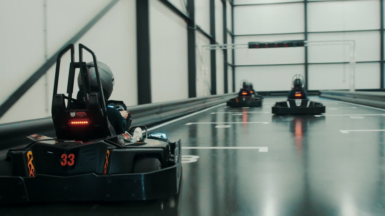 Racing electric go karts in an indoor track with friends