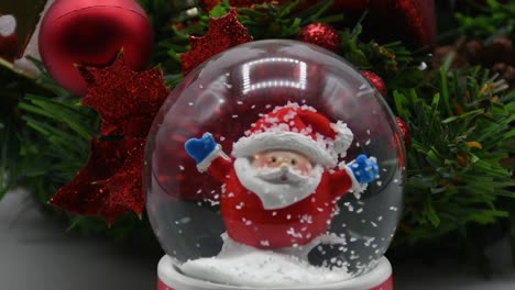 small santa claus in a snow globe