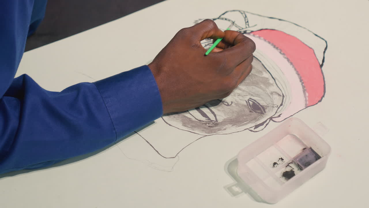 Closeup commission portrait by black artist, final touches with green marker, pink hat refined, paint case beside hand, professional finishing, commercial mood, crisp composition, editorial potential