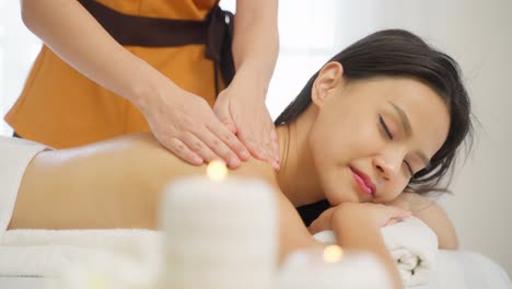 woman receiving a relaxing back massage at a spa